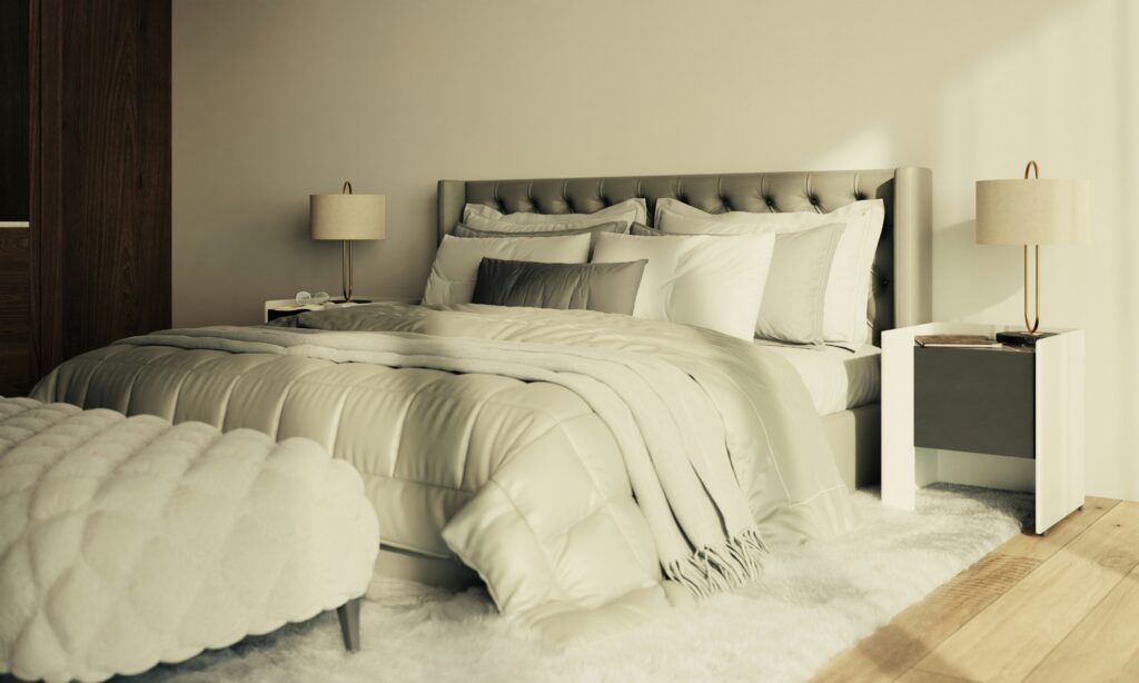 Brightly lit master bedroom featuring a fully made bed and padded headboard.