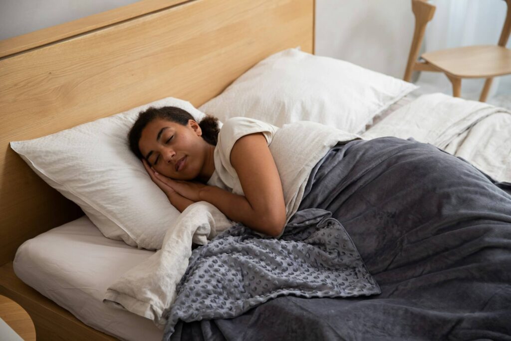 Person lying comfortably in bed resting on a white pillow.